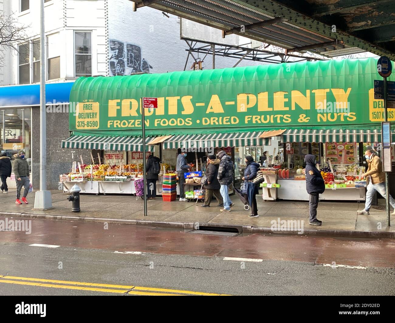 Produce market under the elevated subway station along Kings Highway in