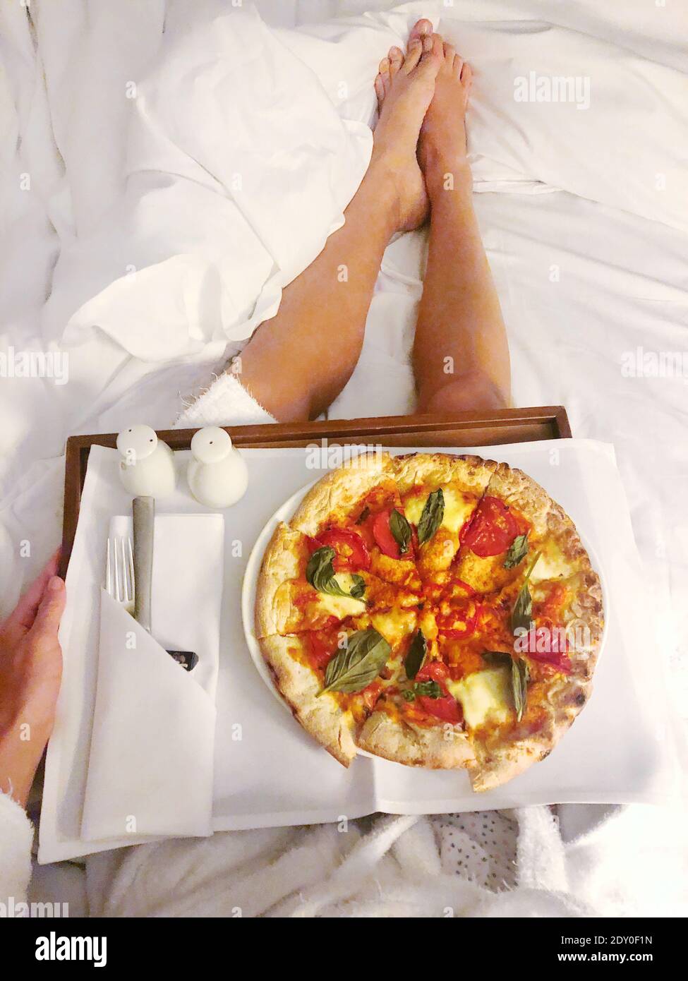 High Angle View Of Woman In The Bathing Robe Eating Pizza Take Out In The  Box In Bed Stock Photo - Alamy