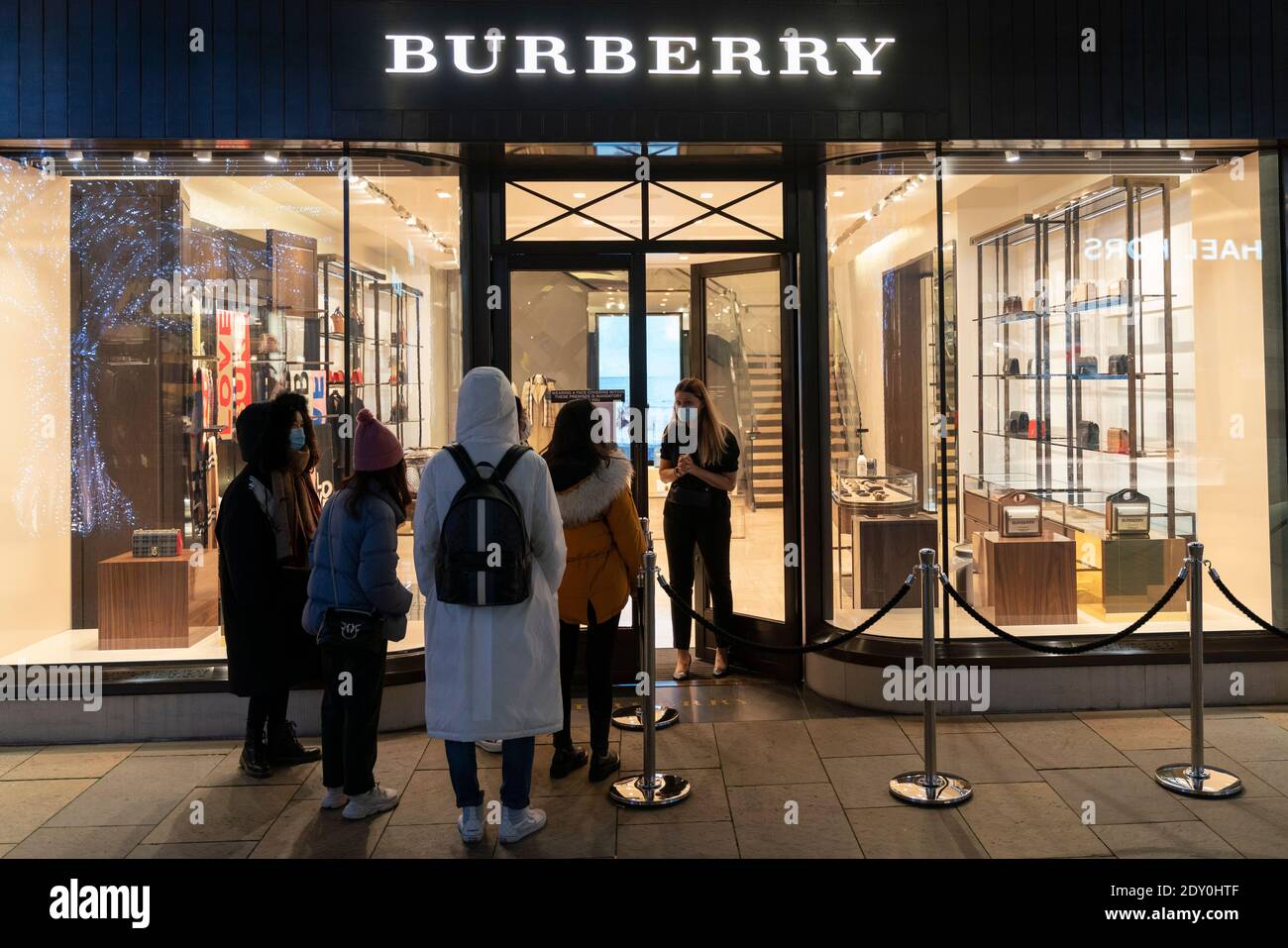 Edinburgh, Scotland, UK. 24 December 2020. Last minute Christmas shopping  just before the shops close on Christmas Eve at upmarket Multrees Walk in  Edinburgh. PoIc; Chinese shoppers too late to enter Burberry