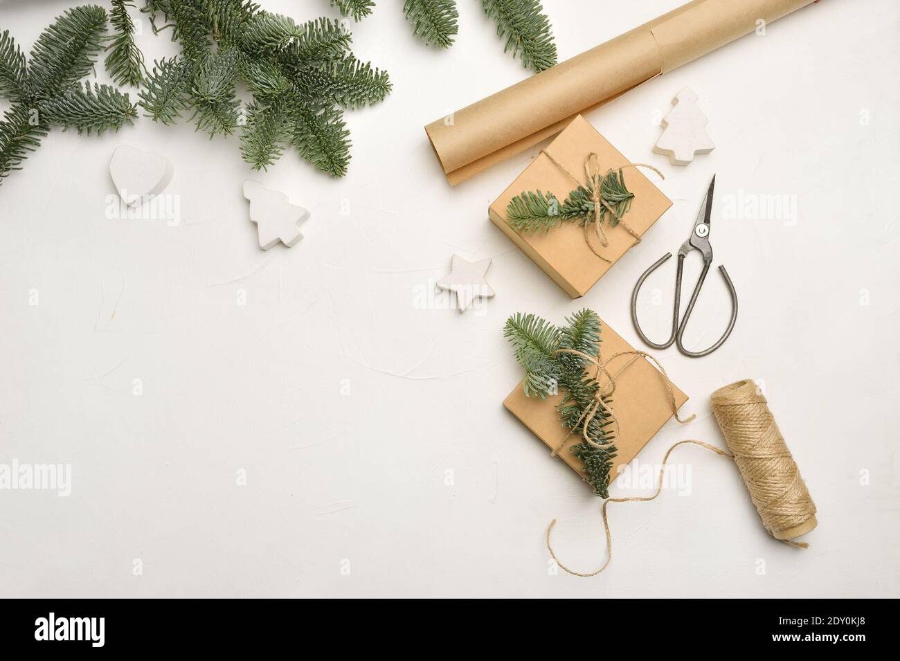 Christmas composition with green fir branches and kraft paper gift ...