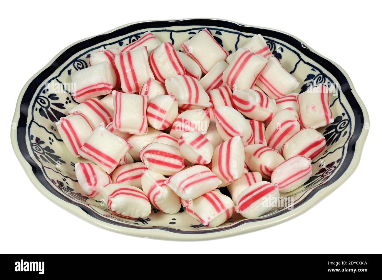 Dutch peppermint confectionery in Delftware bowl isolated on wooden background Stock Photo