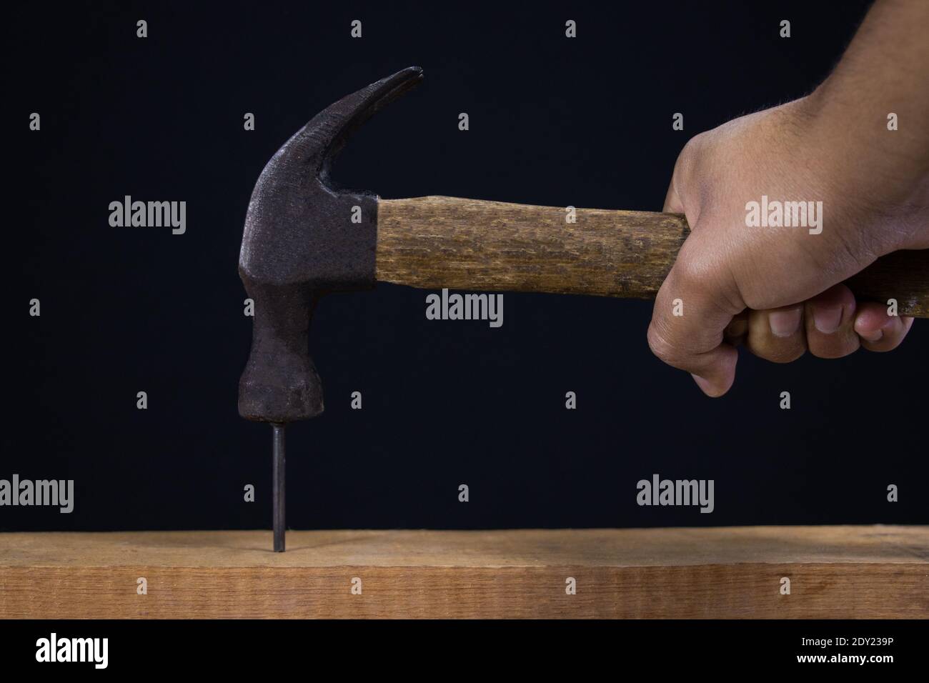 Hammer with nail on black background Stock Photo