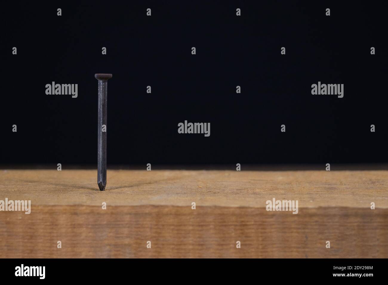 Hammer with nail on black background Stock Photo