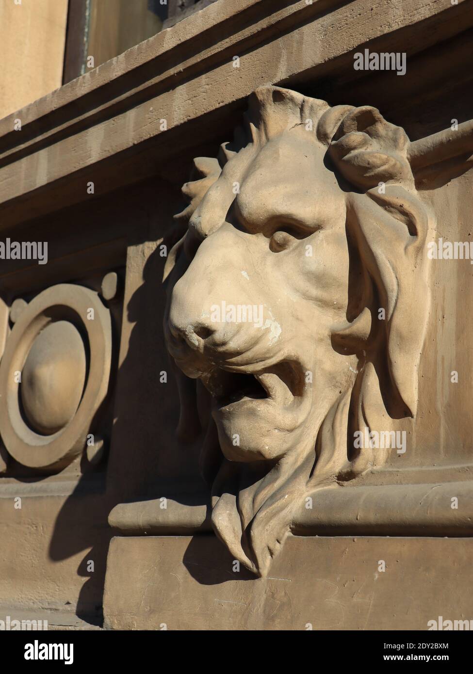 Lion Building Sign A vertical shot of a lion statue on an architectural building Stock ...