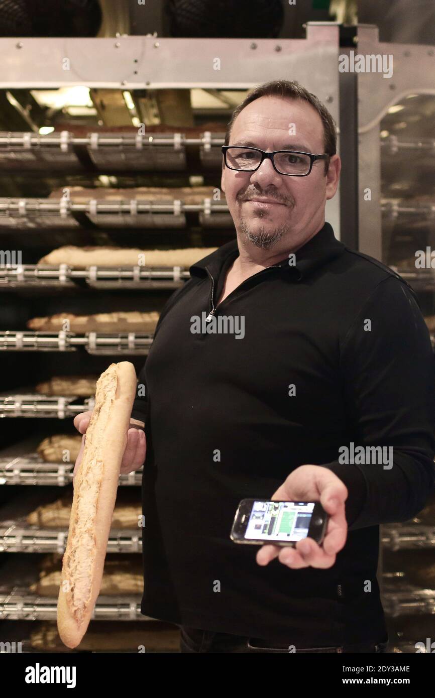 French baker Jean-Louis Hecht stands next to his baguette dispenser, the  PaniVending, during its inauguration outside 'La Panamette' bakery in  Paris, France on October 9, 2014. PaniVending is the first fresh bread