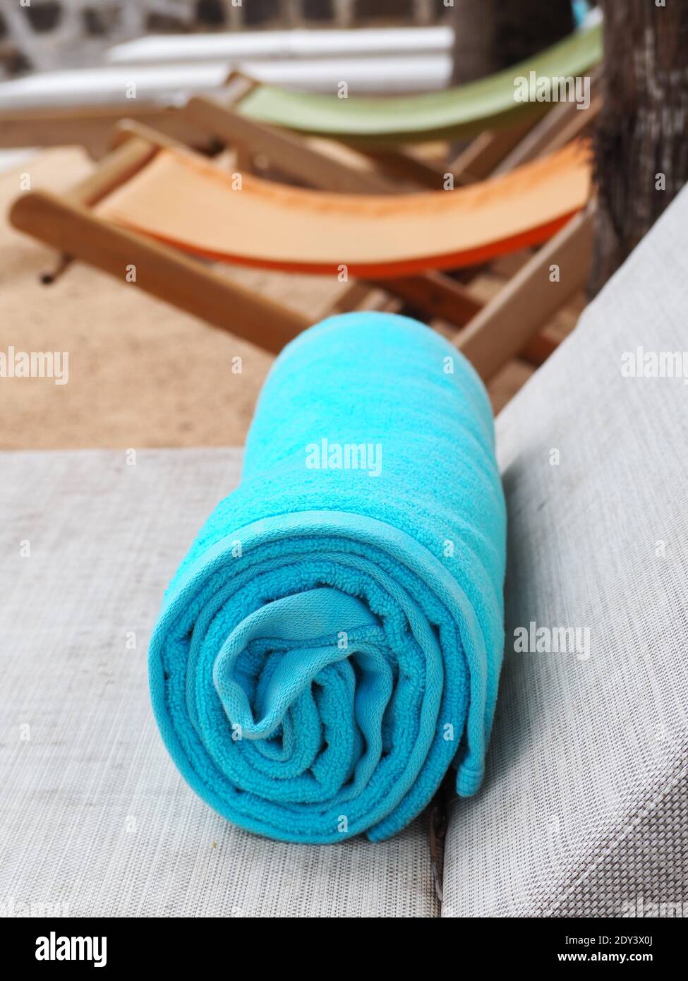 Download High Angle View Of A Blue Rolled Beach Towel On A Long Chair Stock Photo Alamy