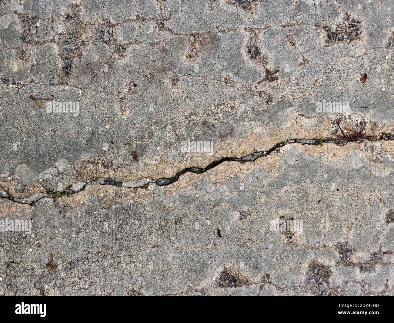 Cracked Weathered And Worn Concrete Driveway Close-up Photograph. Stock Photo