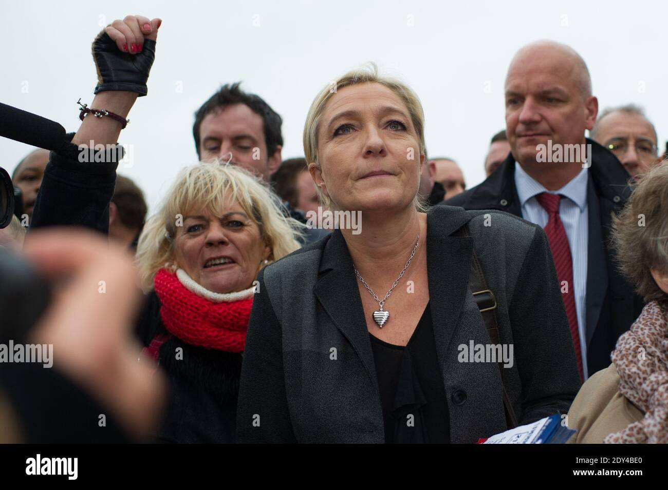 French far-right Front National party president Marine Le Pen walks a  street surrounded by supporters in Calais, northern France on October 24,  2014. Le Pen came to the northern port town to