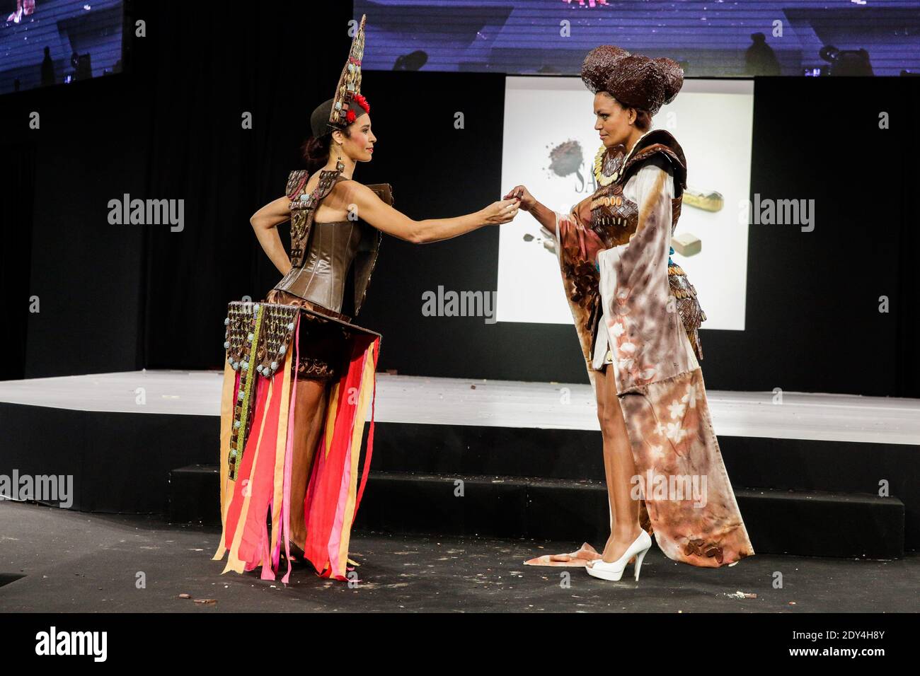 Aida Touihri wears a creation by Maison Rannou-Metivier, Laurence Roustandjee wears a creation by Audrey Lempeseur and Frederic Cassel, made with chocolate during a fashion show at the inauguration of the 20th annual Salon du Chocolat in Paris, France on October 28, 2014. The show, the world's biggest dedicated to chocolate, brings together fashion designers and chocolatiers from around the world. Photo by Jerome Domine/ABACAPRESS.COM Stock Photo