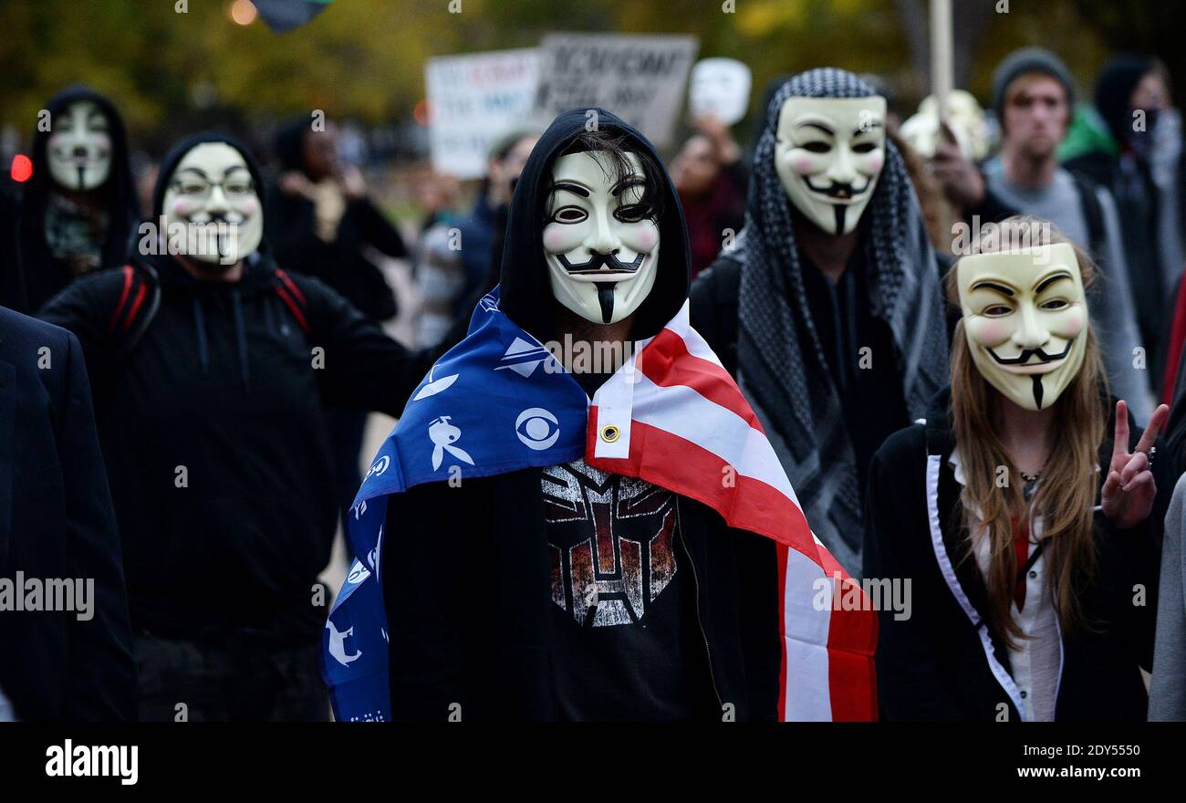 Anonymous and pro-democracy protesters wearing Guy Fawkes masks walk in front of the White House in Washington, DC, USA, for the Million Mask March, November 5, 2014. The Million Mask March is sweeping the globe across Wednesday as demonstrators protest against austerity, mass surveillance and oppression. Photo by Olivier Douliery/ABACAPRESS.COM Stock Photo