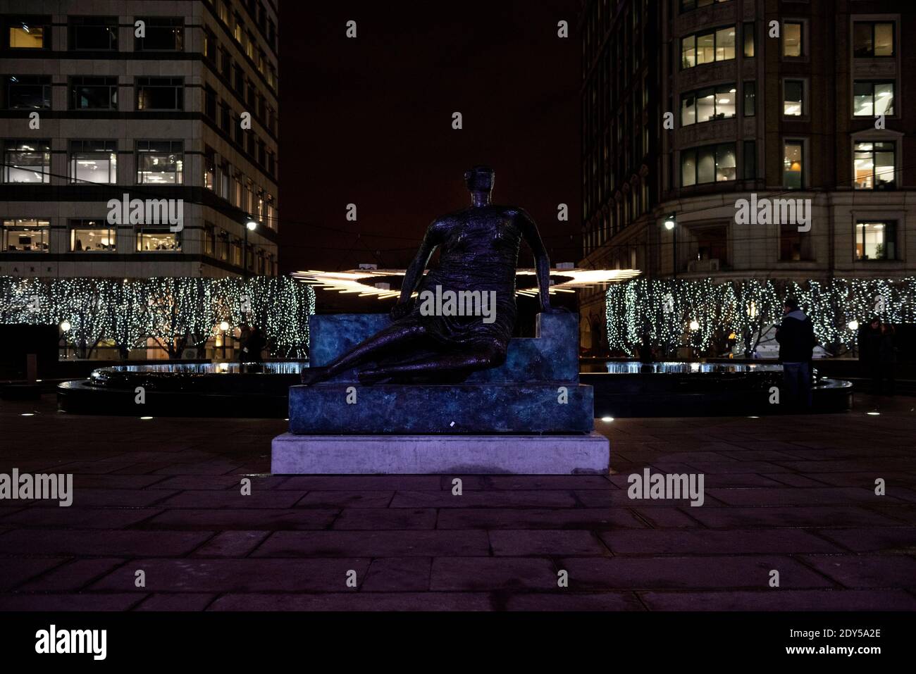 Statue of ‘Draped Seated Woman’ by Henry Moore in Cabot Square, Canary Wharf, London, UK. Winter Lights festival, 2018. Stock Photo