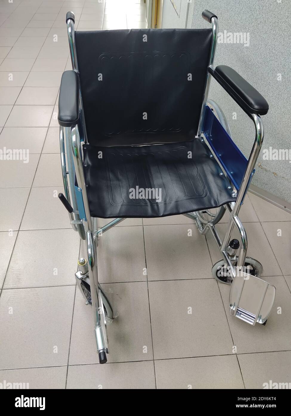 High Angle View Of Empty Wheelchair On Tiled Floor Stock Photo