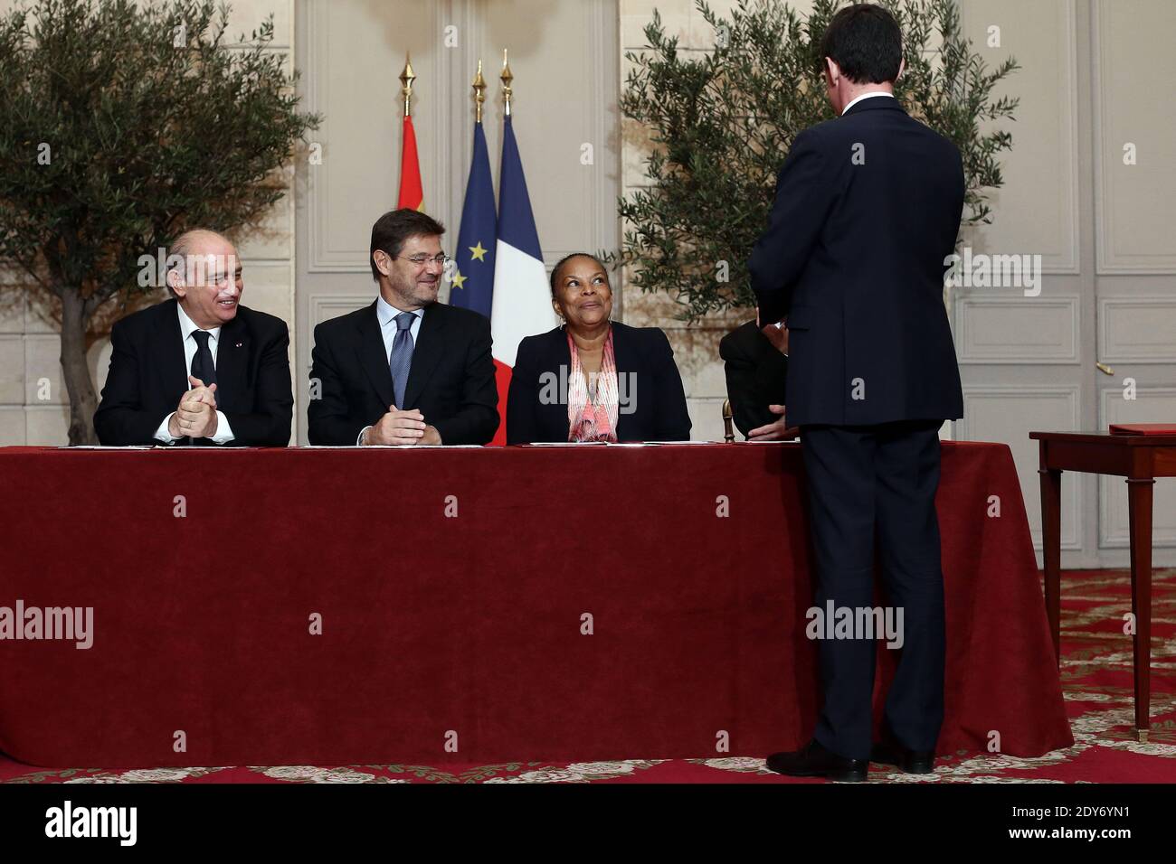 French Prime Minister Manuel Valls (R) looks on while Spanish Minister of the Interior Jorge Fernandez Diaz, Spanish Minister of Justice Rafael Catala, French Minister of Justice Christiane Taubira and French Minister of the Interior Bernard Cazeneuve wait to sign an agreement as part of the 24th Franco-Spanish Summit, at the Elysee Palace, in Paris, France on December 1, 2014. Photo by Stephane Lemouton/ABACAPRESS.COM Stock Photo