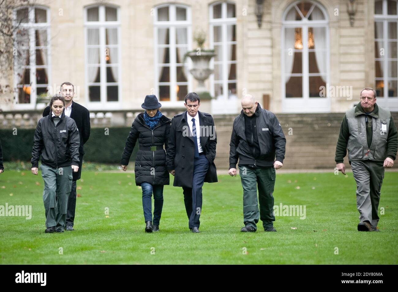 French Prime Minister Manuel Valls arriving along with his wife Anne Gravoin and gardeners to plant the tree called 'of the Prime Minister' - as is the republican tradition - in the gardens of his headquarters Hotel de Matignon in Paris, France on December 16, 2014. The tree, chosen by the Prime Minister, is an oak of the species 'Quercus robur fastigiata' and is located on the front lawn. The tradition of planting a tree at the PM's headquarters was introduced by the late Prime Minister Raymond Barre in 1978. Photo Pool by Nicolas Messyasz/ABACAPRESS.COM Stock Photo