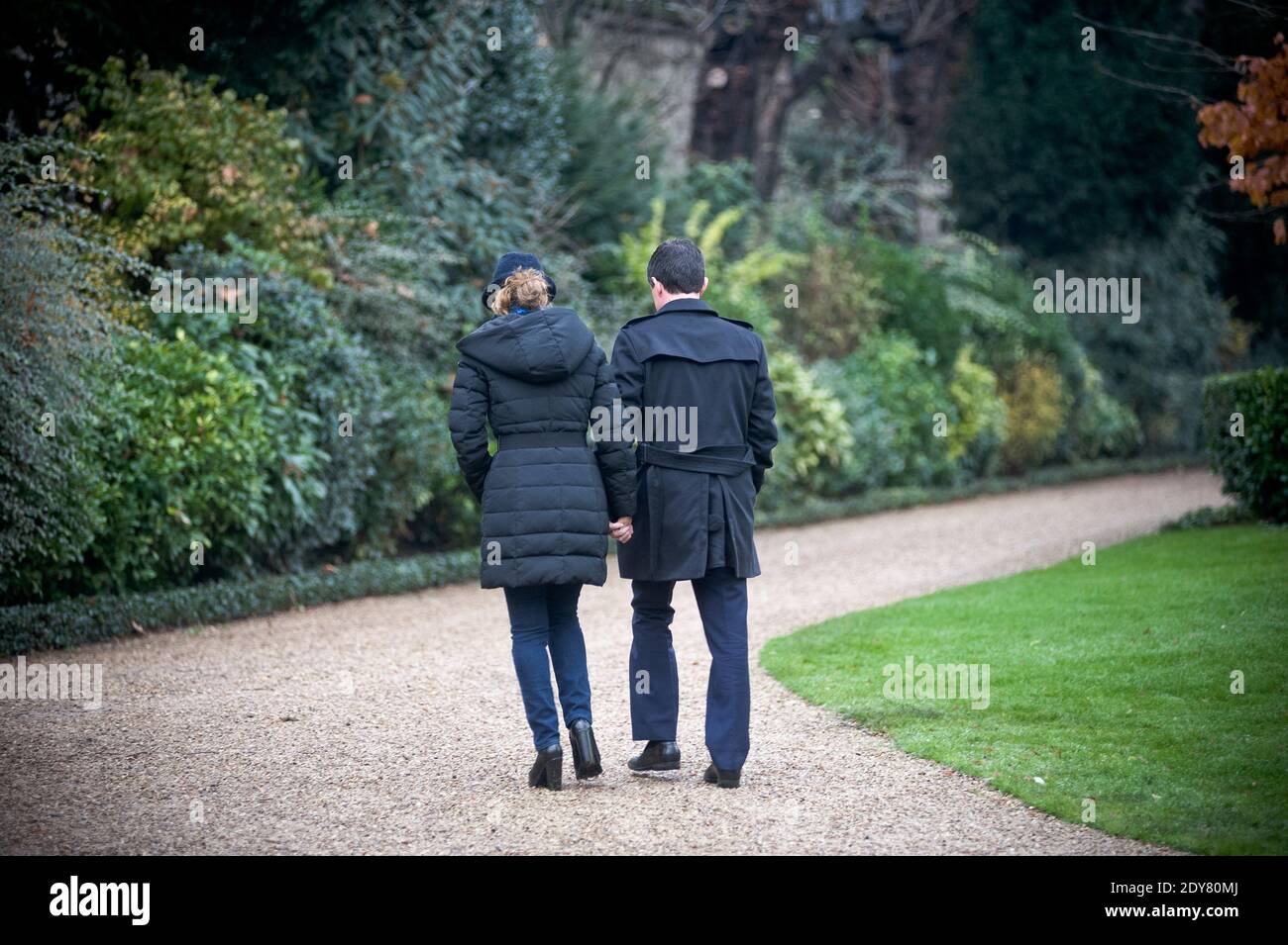 French Prime Minister Manuel Valls along with his wife Anne Gravoin leaves after planting the tree called 'of the Prime Minister' - as is the republican tradition - in the gardens of his headquarters Hotel de Matignon in Paris, France on December 16, 2014. The tree, chosen by the Prime Minister, is an oak of the species 'Quercus robur fastigiata' and is located on the front lawn. The tradition of planting a tree at the PM's headquarters was introduced by the late Prime Minister Raymond Barre in 1978. Photo Pool by Nicolas Messyasz/ABACAPRESS.COM Stock Photo