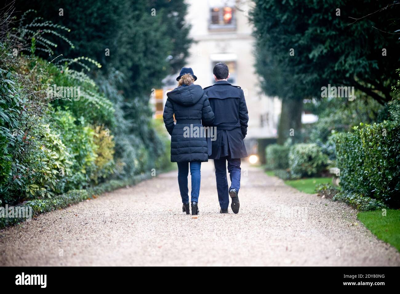 French Prime Minister Manuel Valls along with his wife Anne Gravoin leaves after planting the tree called 'of the Prime Minister' - as is the republican tradition - in the gardens of his headquarters Hotel de Matignon in Paris, France on December 16, 2014. The tree, chosen by the Prime Minister, is an oak of the species 'Quercus robur fastigiata' and is located on the front lawn. The tradition of planting a tree at the PM's headquarters was introduced by the late Prime Minister Raymond Barre in 1978. Photo Pool by Nicolas Messyasz/ABACAPRESS.COM Stock Photo