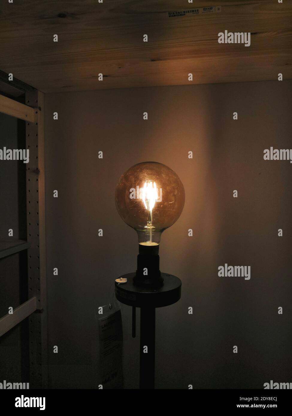 Illuminated Light Bulb In Darkroom Stock Photo Alamy