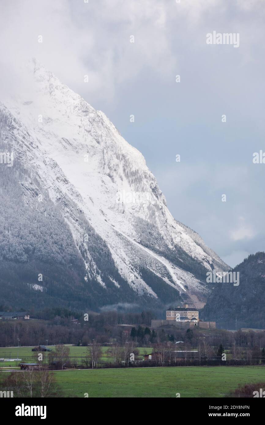 Winter landscape with snow covered Grimming mountain and Trautenfels Castle in the district of Liezen in Styria, Austria Stock Photo