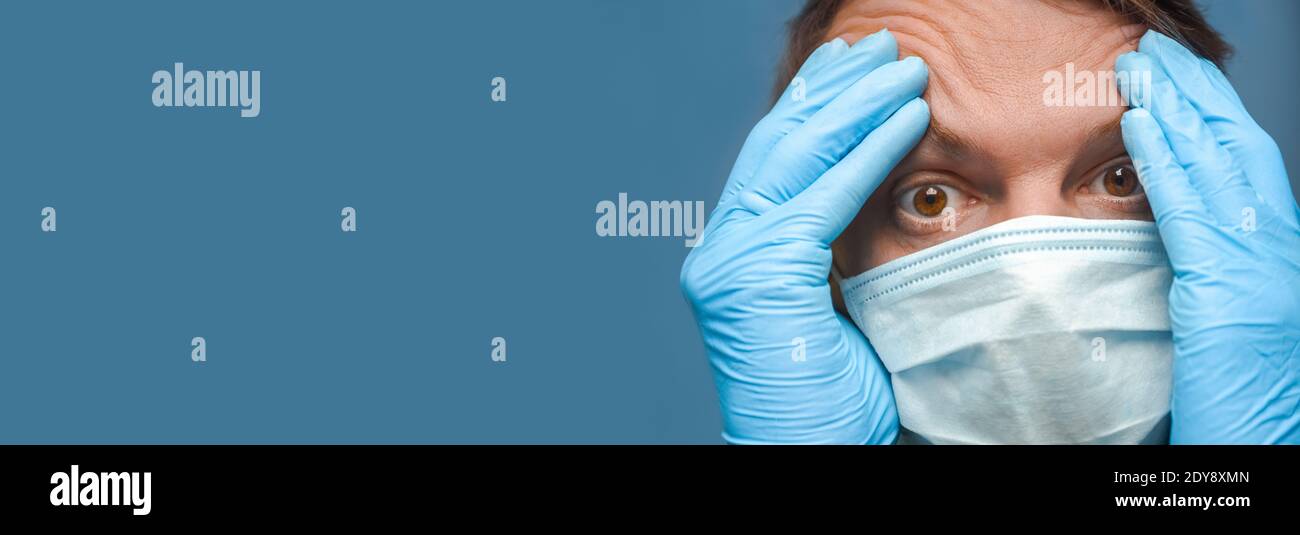 Stressed man. Depressed coronavirus. Hands on head Covid-19. Man stressful. Panic corona. Close up. Negative emotions. Banner. Under Stress. Stressful Stock Photo