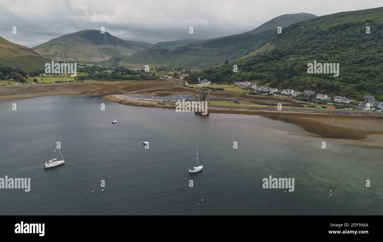 Yachts, ships, boats at Scotland ocean aerial. Seascape of sea bayAmazing nobody nature landscape at summer cloudy day. Cinematic cruise scenery at Arran Island, United Kingdom, Europe Stock Photo