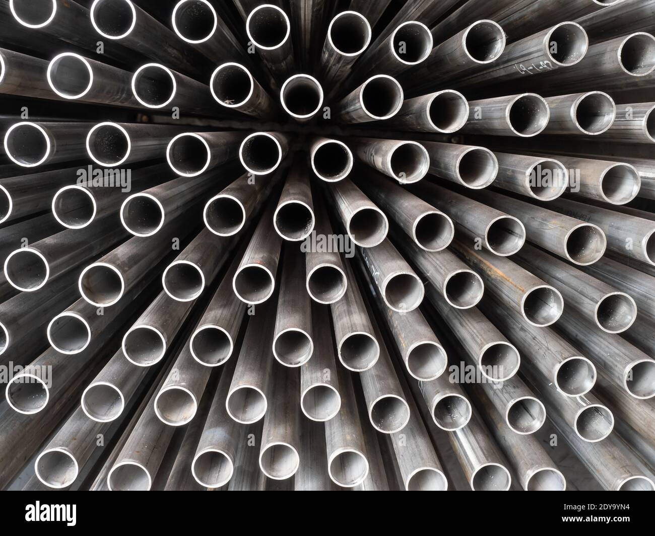 Somewhat dirty stainless steel tubes sticking out from a rack Stock