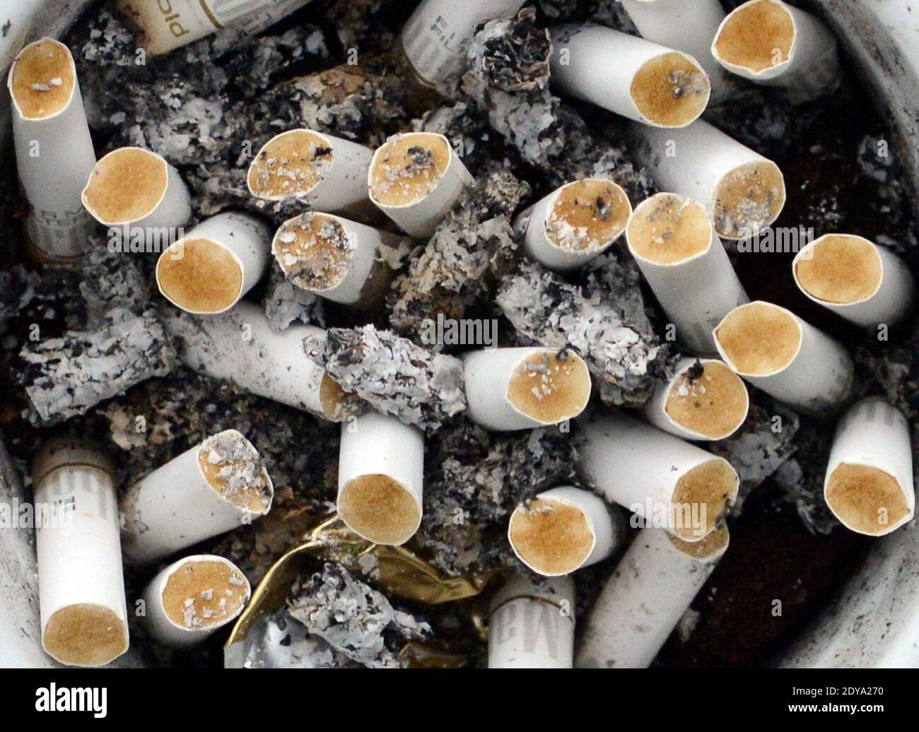 An ashtray full of cigarette butts. Stock Photo