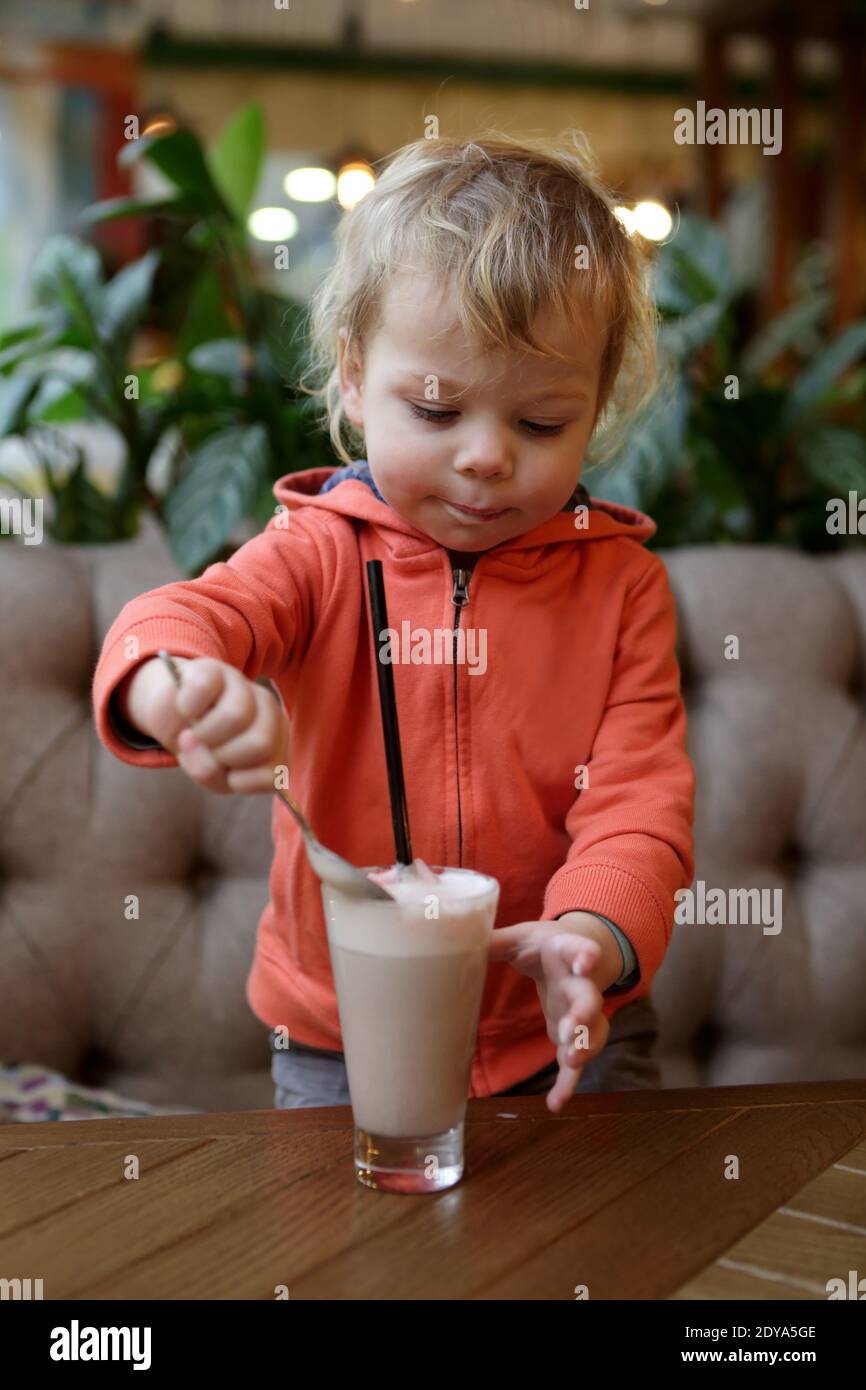 Boy eating foam of cocoa in cafe Stock Photo Alamy