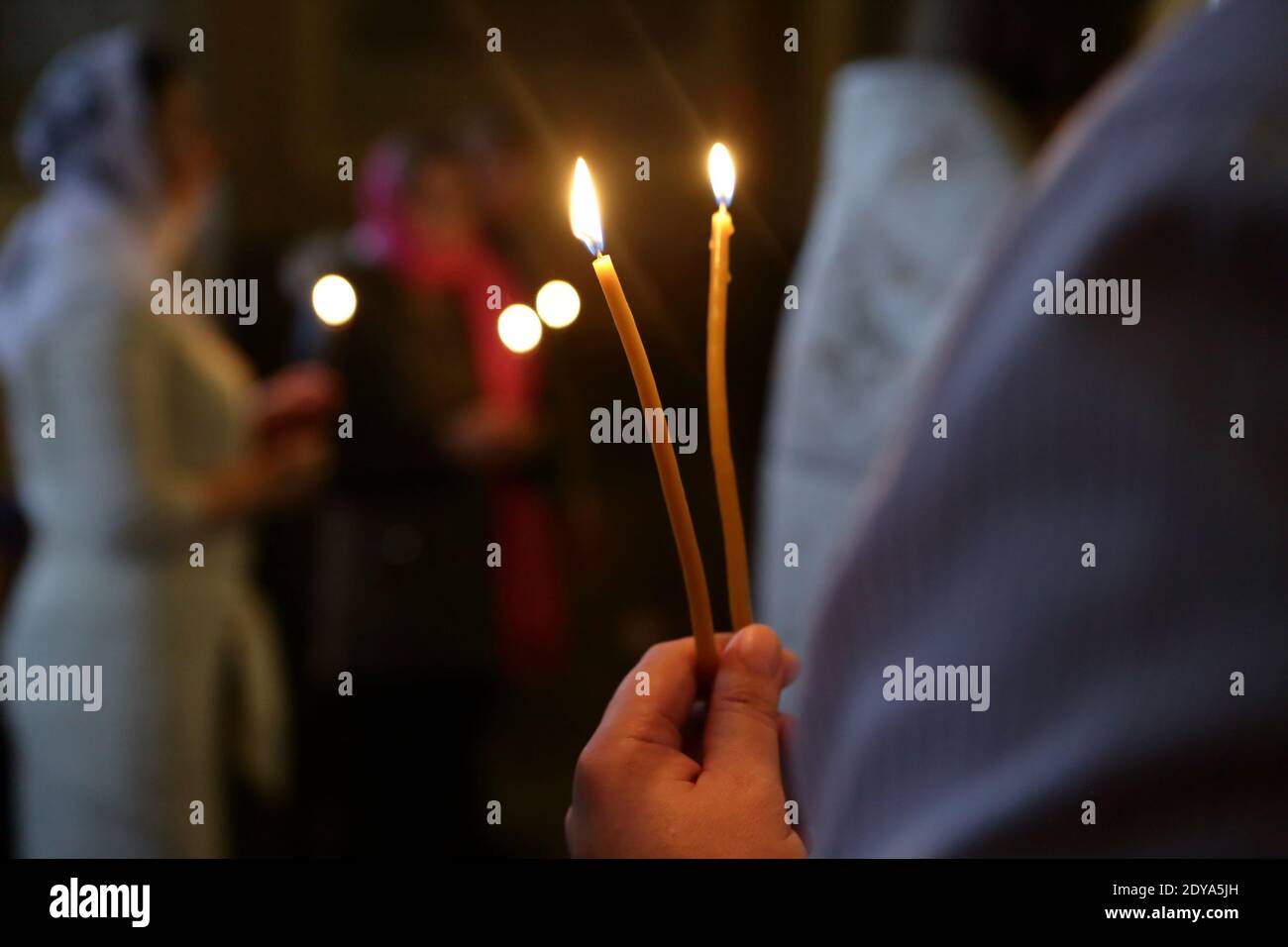 Person holding candles church hi-res stock photography and images - Alamy