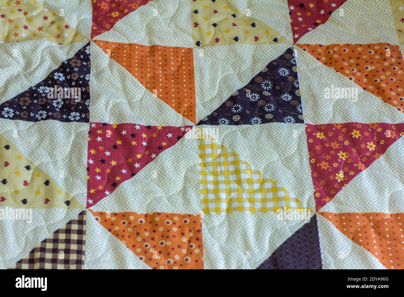 Quilt. A fragment of a patchwork quilt as a background. Colored ...