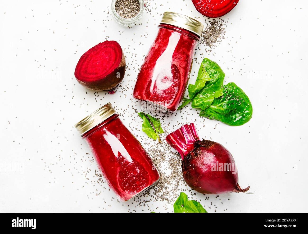Beetroot smoothies with chia seeds, glass bottles, gray background, top ...