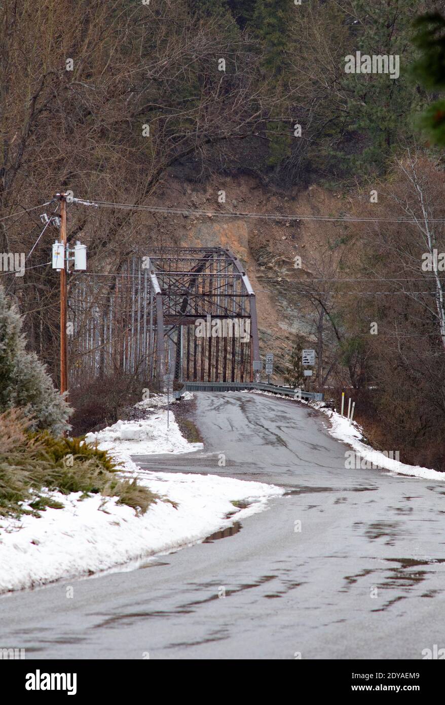 The Theodore Roosevelt Memorial Bridge, over the Kootenai River, on a snowy, cold winter day, in Troy, Montana.  The Kootenai River is a tributary of Stock Photo