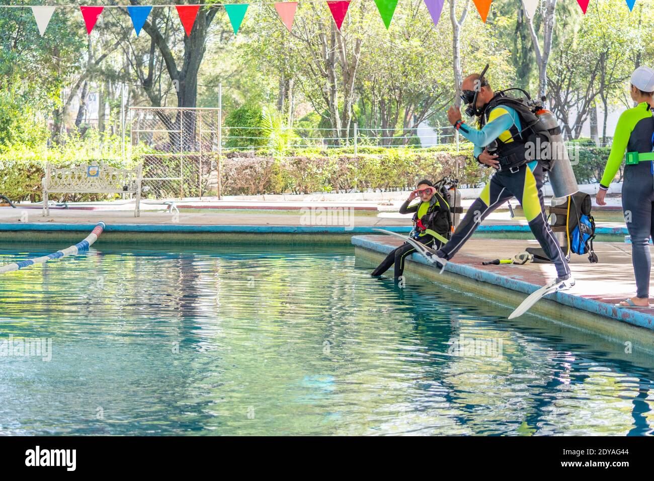 teacher in diving classes teaching how to enter the water correctly ...