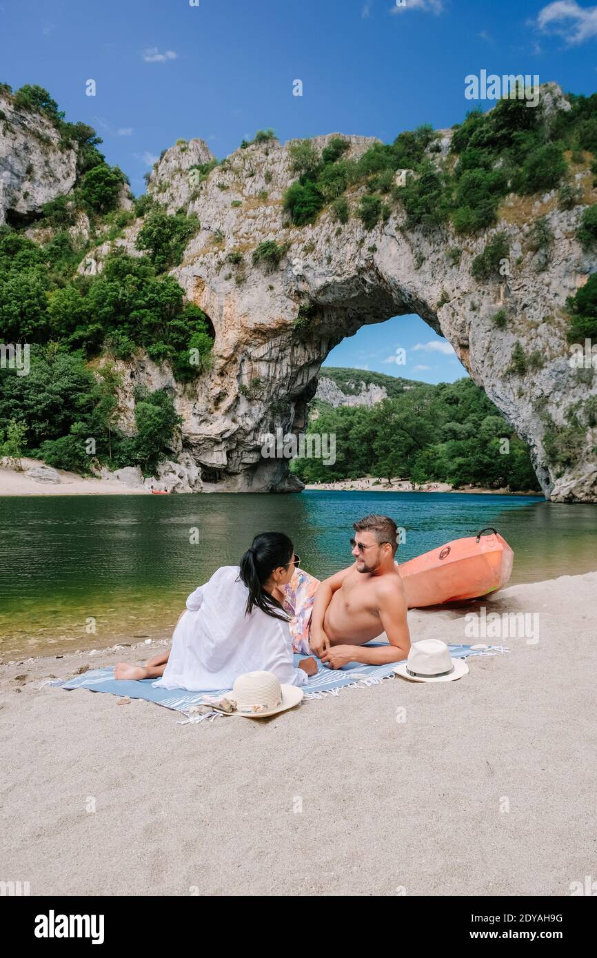 couple on vacation in the Ardeche France , young men and woman visiting Narural arch in Vallon Pont D'arc in Ardeche canyon in France. Europe Stock Photo