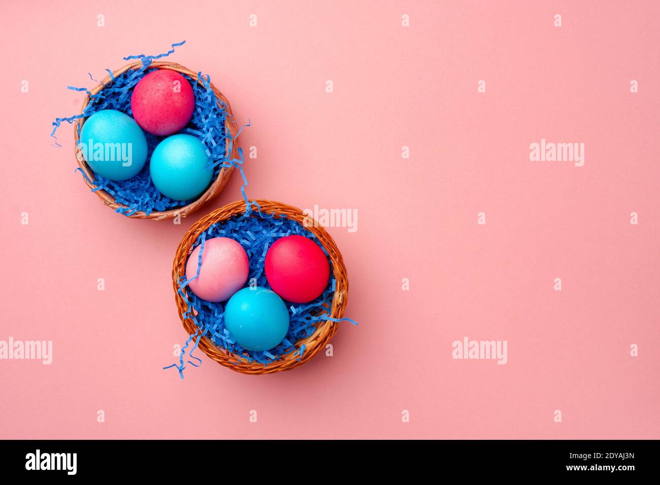 Painted Easter eggs in decorative nest on pink background Stock Photo ...