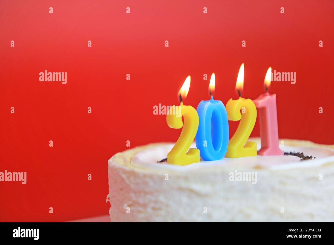 2021 calendar on the cake with red background Stock Photo