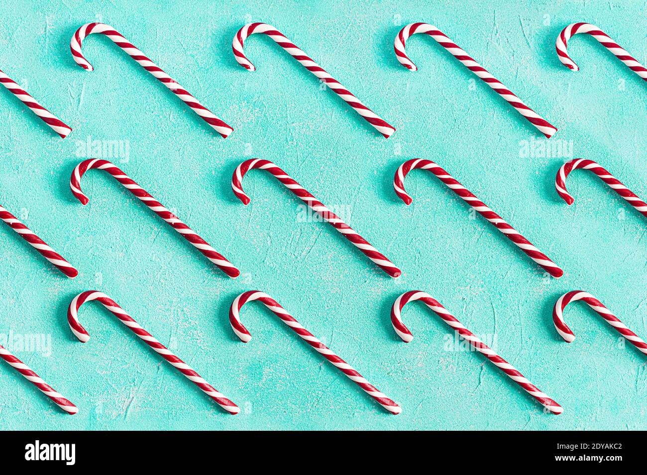 Christmas striped candy cane isolated on blue background. Candy cane pattern. Top view Stock Photo