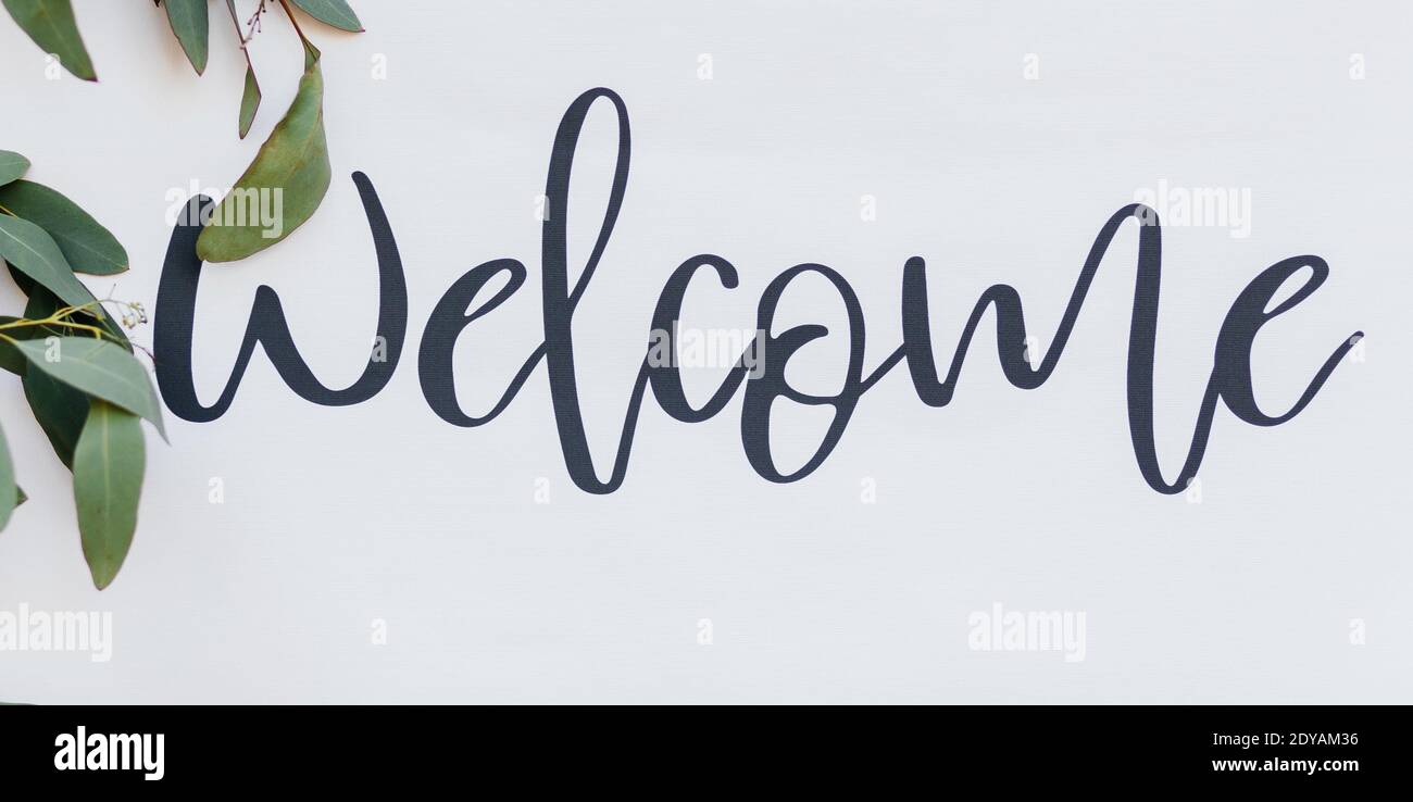 Sign WELCOME on the white background. Invitation to guests at the wedding Stock Photo