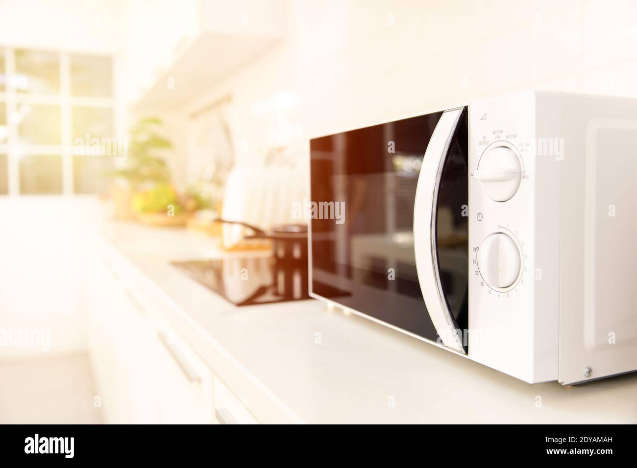 Kitchen counter closeup microwave oven cooking machine Stock Photo