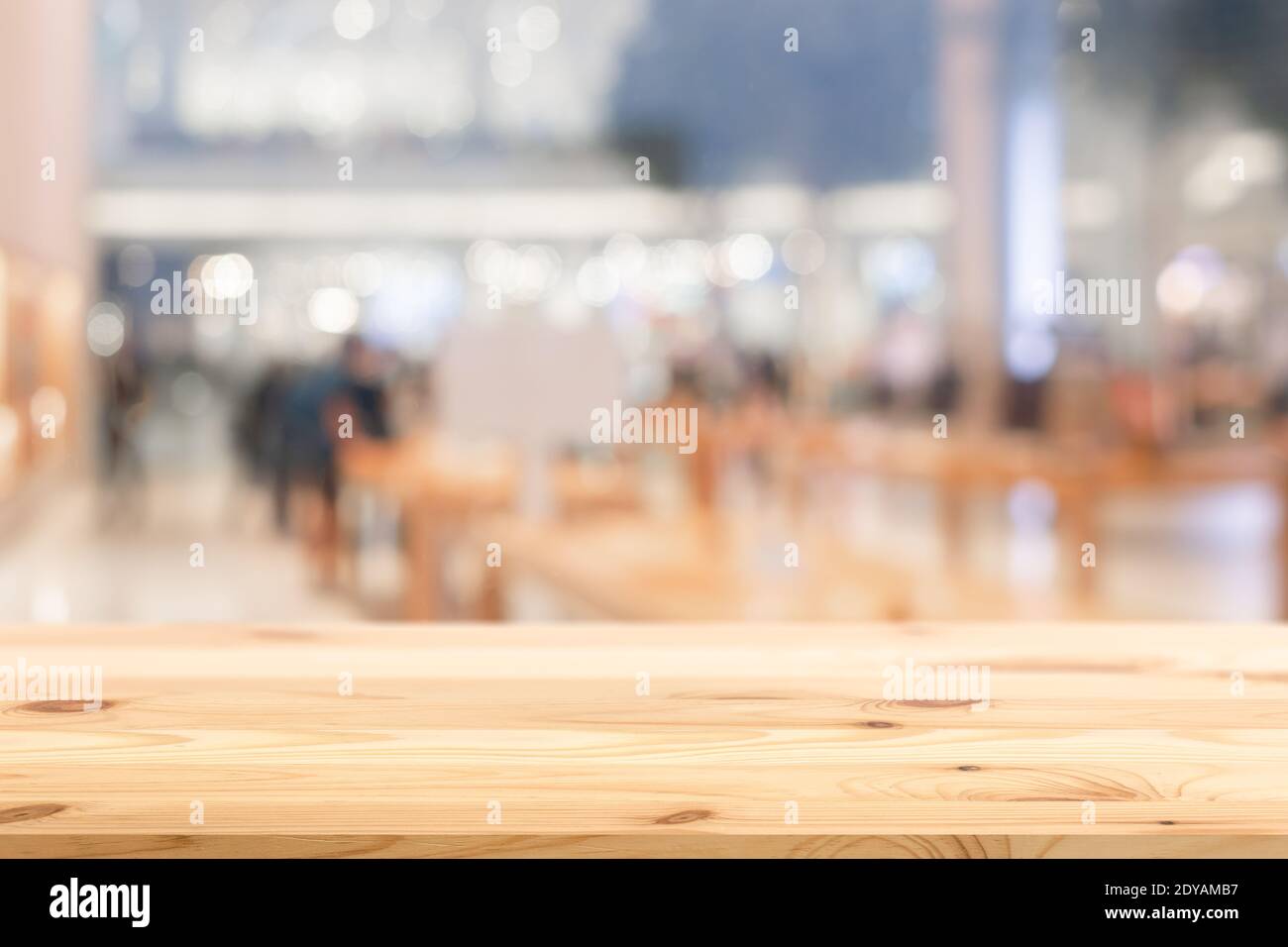 Blur business store shop with wooden table foreground blank for products advertising montage background. Stock Photo
