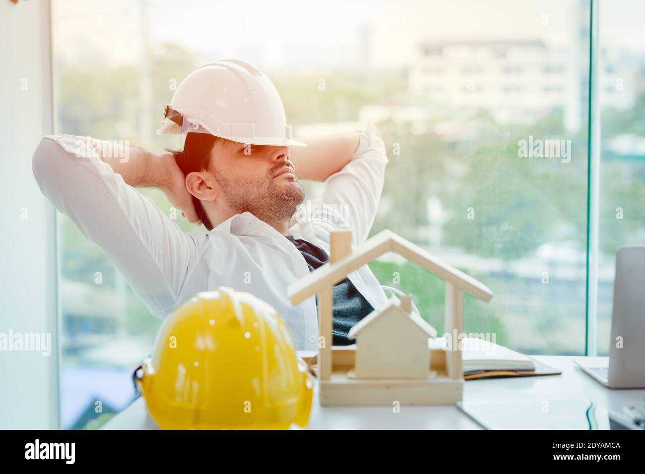 engineer tired and napping or sleeping in the office when lunch brake time after hard work overnight Stock Photo