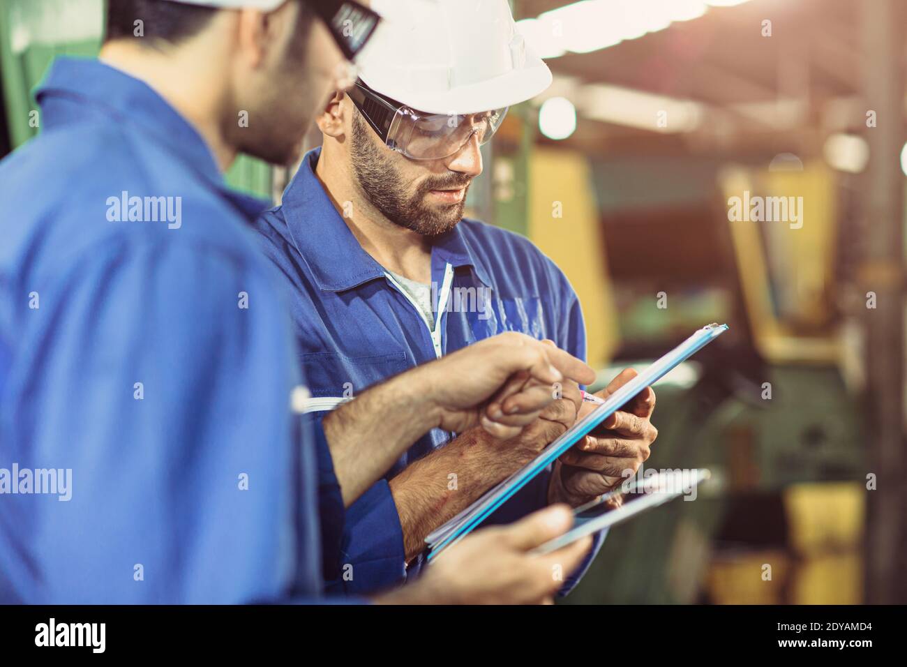 Worker working team work help care support together with safety uniform in industry factory. Stock Photo