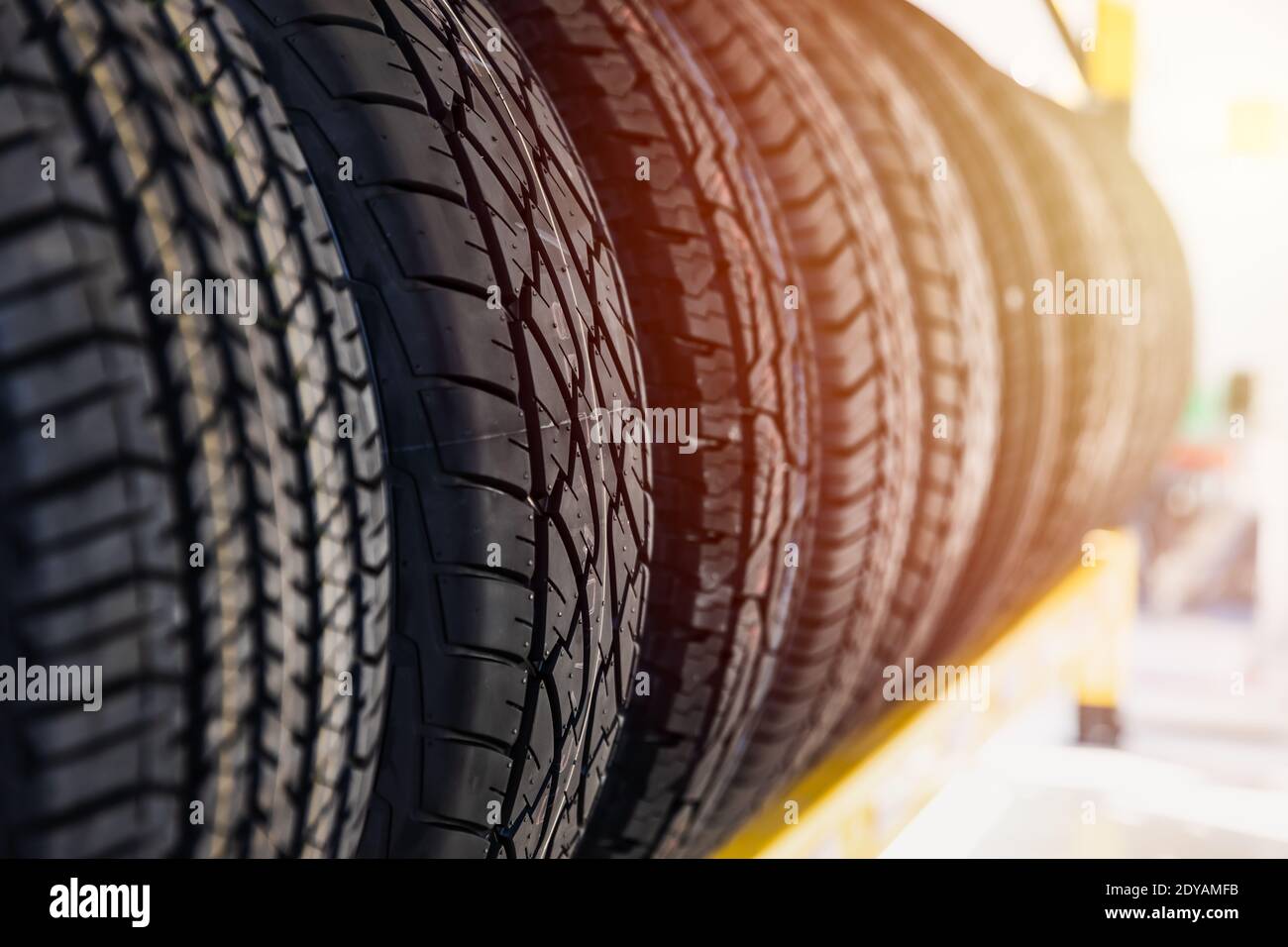 Car tires on shelf in garage shop for sale various type of tyre. Stock Photo