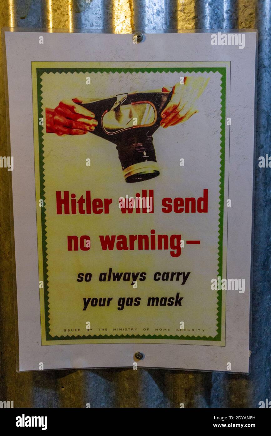 WWII poster, 'Hitler Will send no warning' poster reminding people to carry their gas mask, City of Caves, Nottingham, Notts., UK. Stock Photo