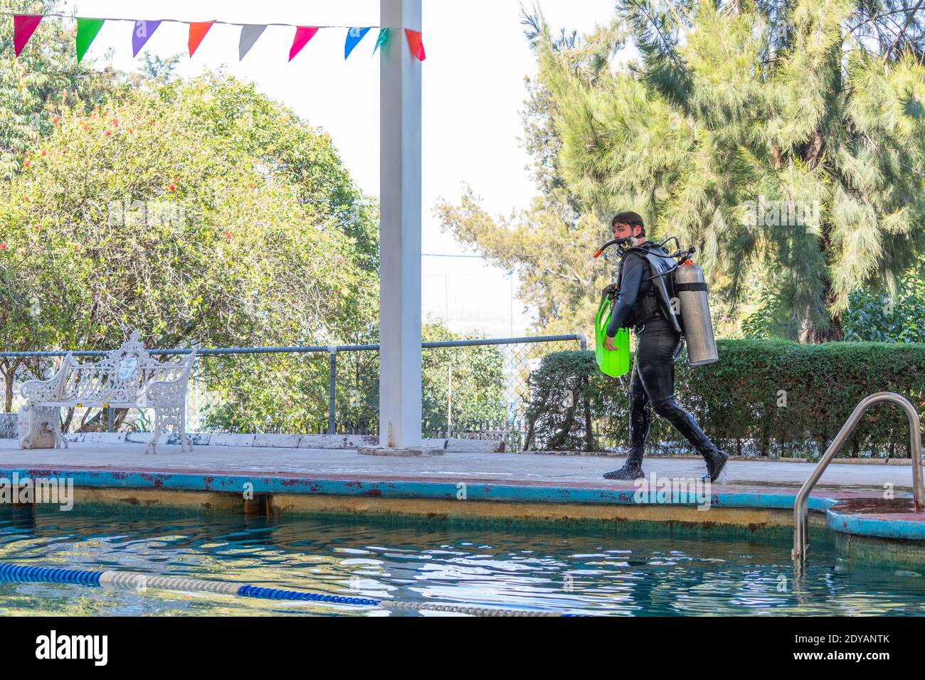 diver walking by the pool after his diving class Stock Photo