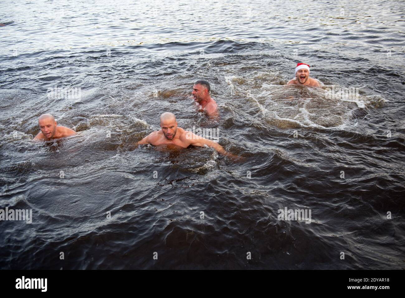 Swimmers take a Christmas Day dip at Blackroot Pool at Sutton Park, in