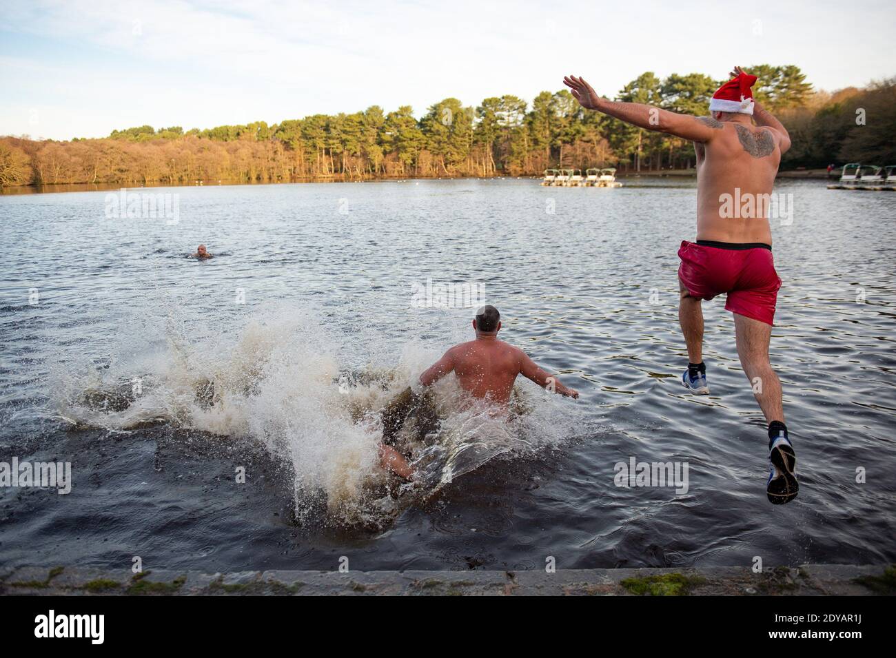Swimmers take a Christmas Day dip at Blackroot Pool at Sutton Park, in