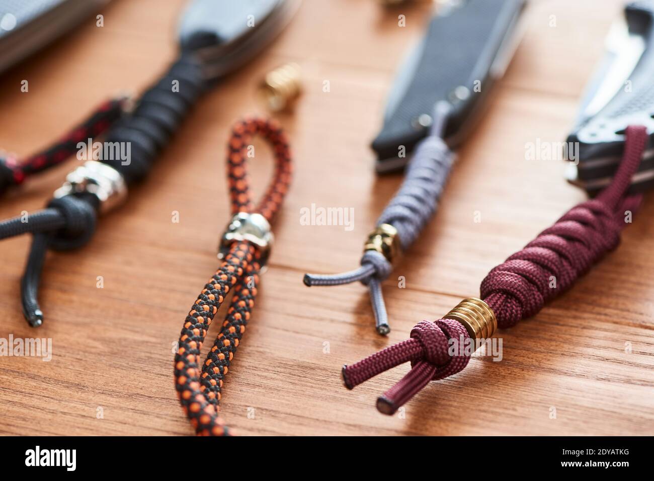 Set of folding knives with various handmade paracord lanyards Stock Photo -  Alamy