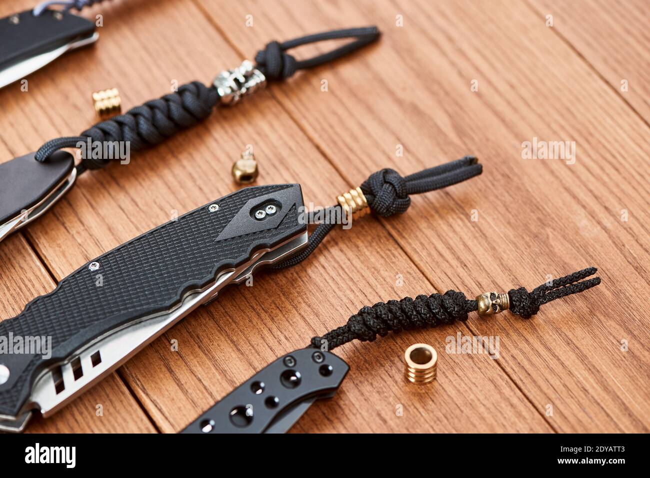 Row of pocket knives decorated with handmade paracord lanyards Stock Photo  - Alamy