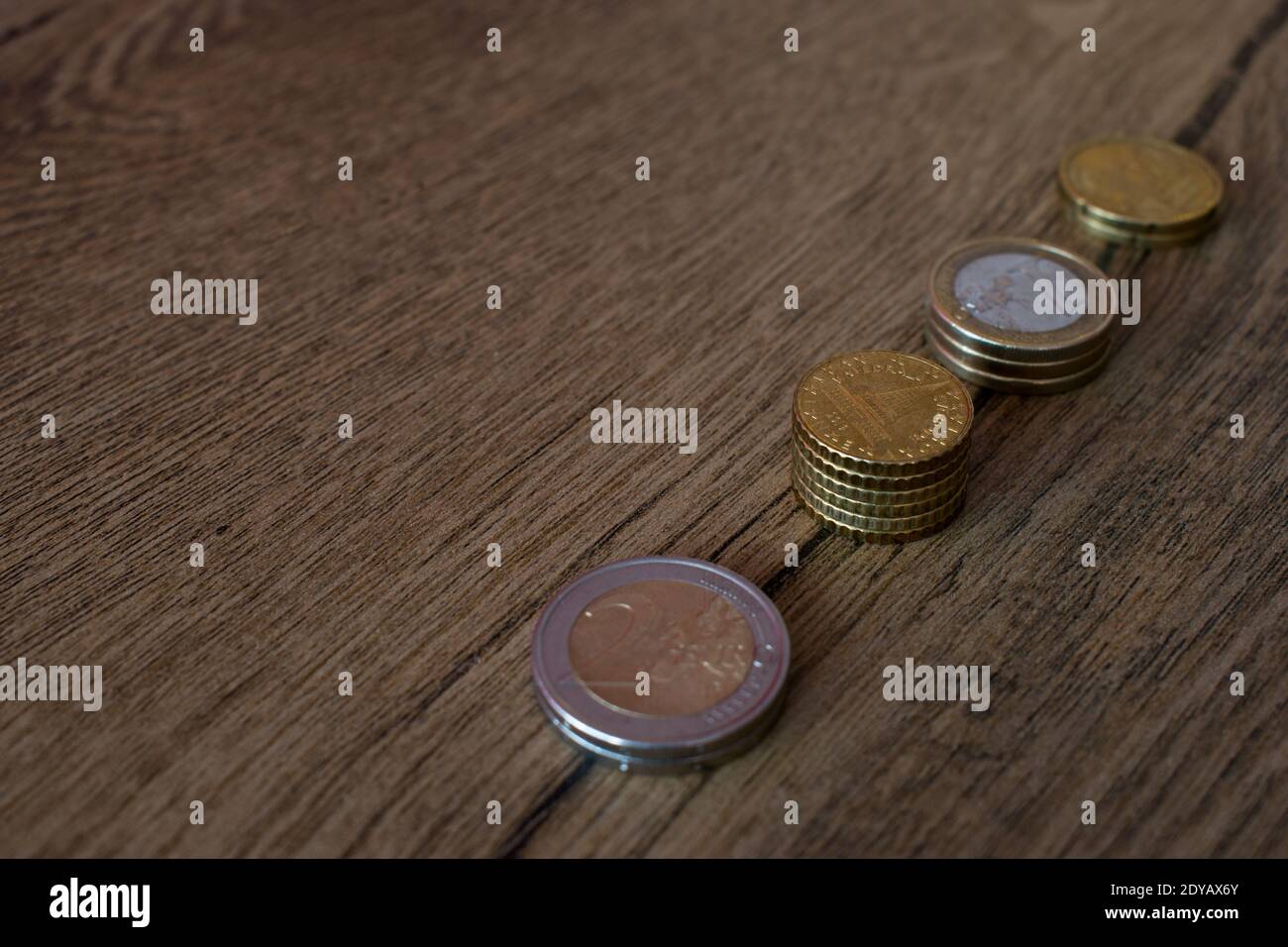 Stacked coins on wooden background Stock Photo