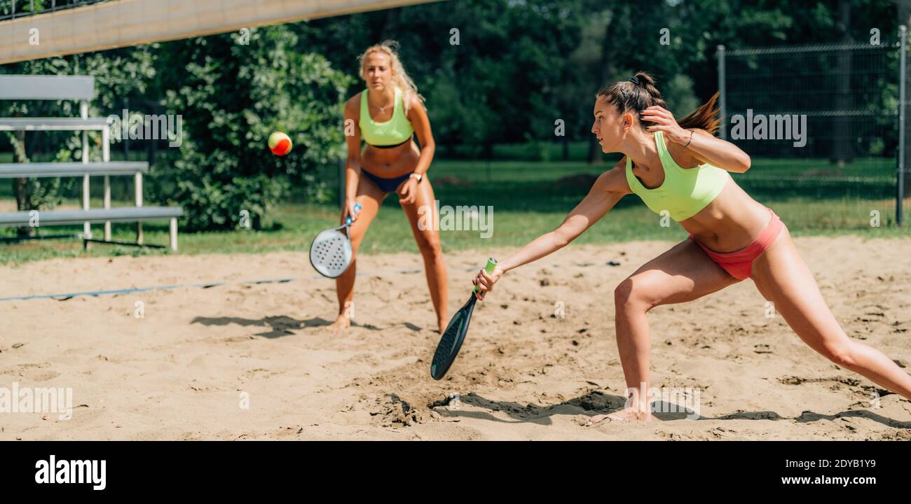 Beach Tennis Player Hits The Ball Stock Photo - Alamy